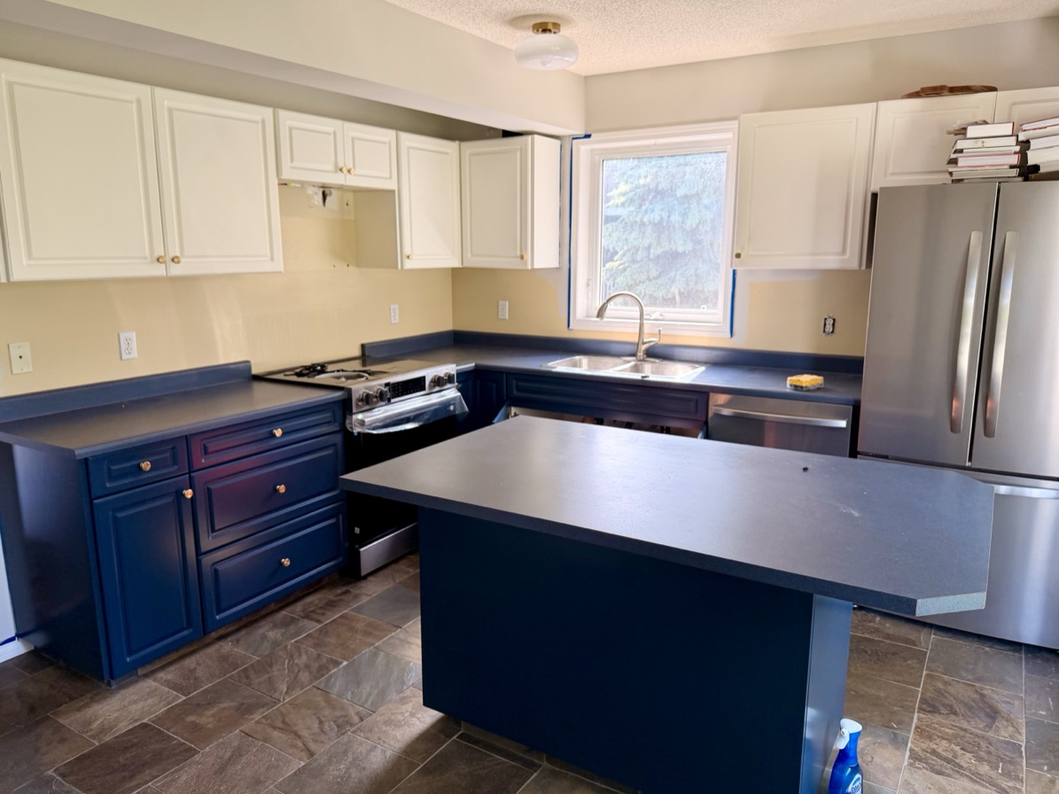 A kitchen before, with the old dark countertops