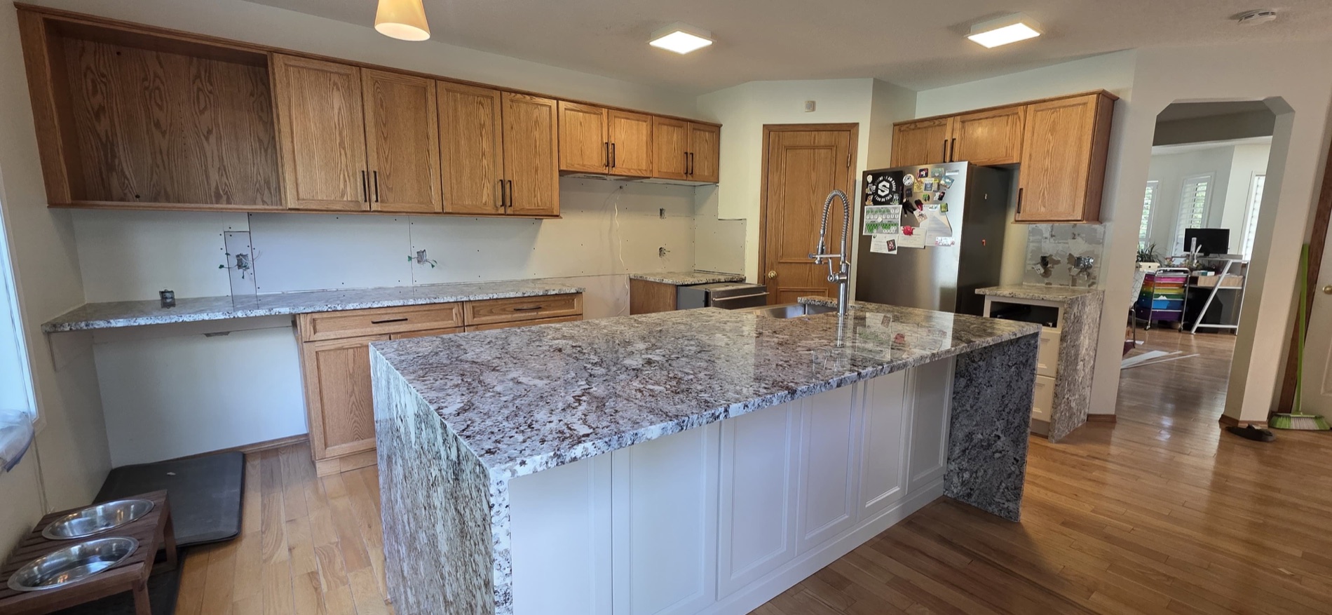 Wide granite waterfall island install in a Calgary kitchen