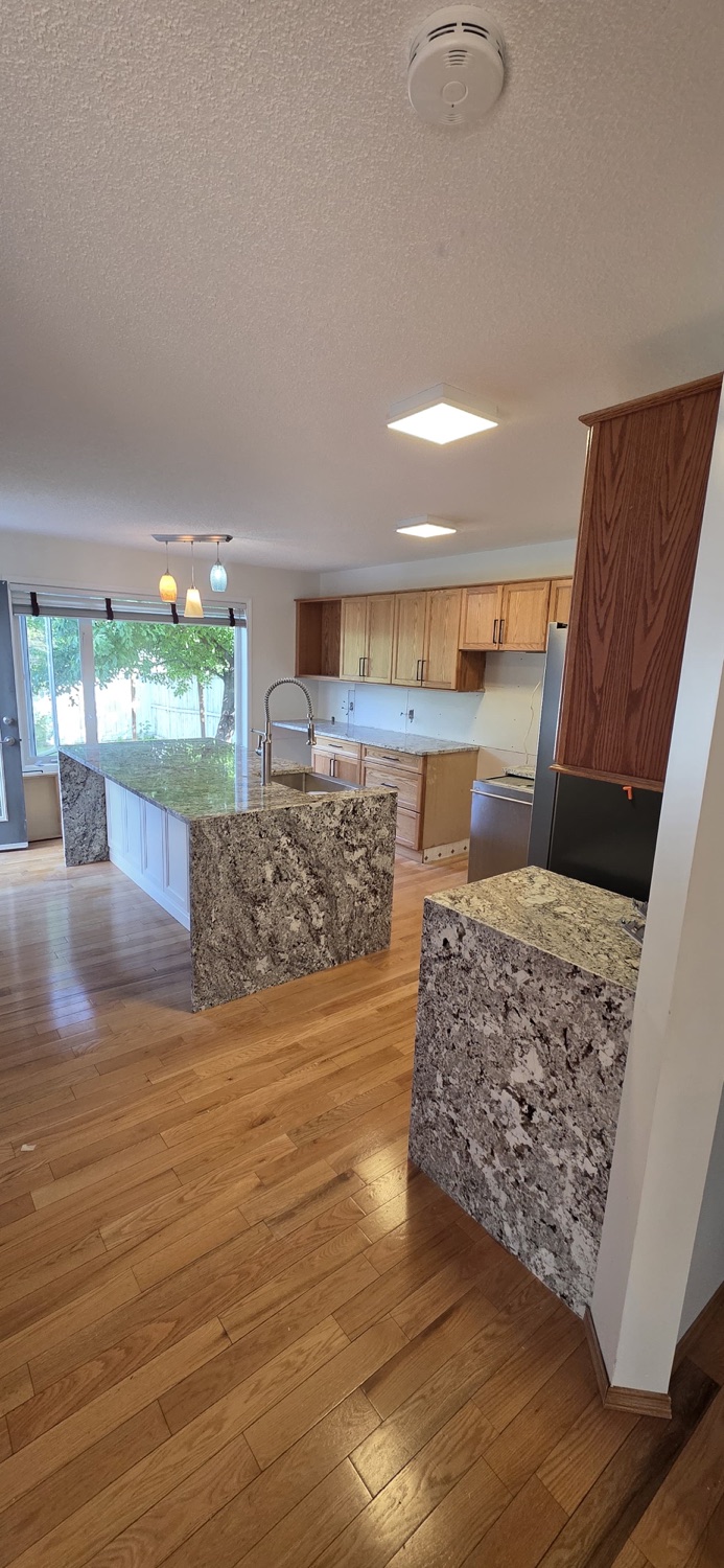 Full kitchen with granite island and counters